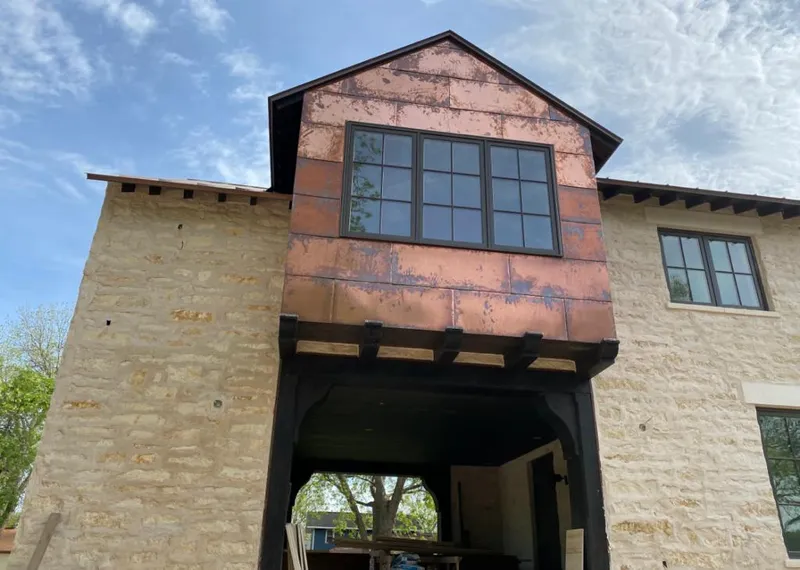 Copper metal panel facade on a stone building for Skylight Installation in Grosse Pointe