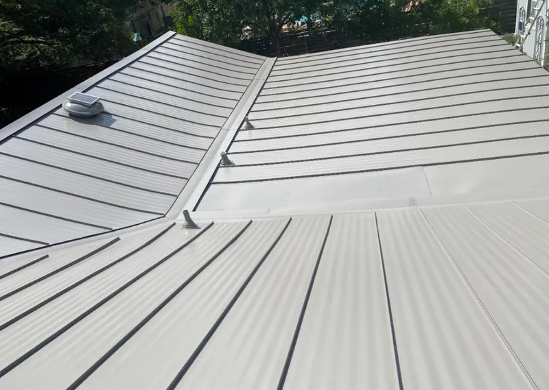 Solar attic fan installed on a metal roof for Roof Ventilation in Grosse Pointe